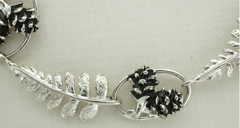 Silver Fern and Pine Cone Necklace - close up view